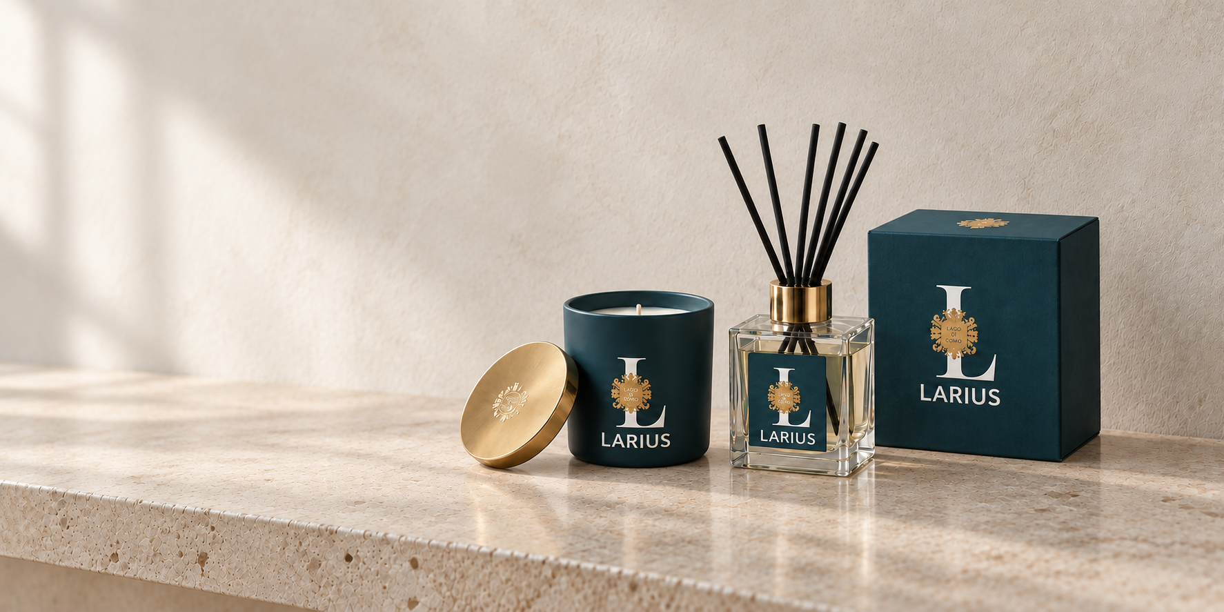 LARIUS candle, reed diffuser and blue-green presentation box on pale stone against a softly lit plaster wall